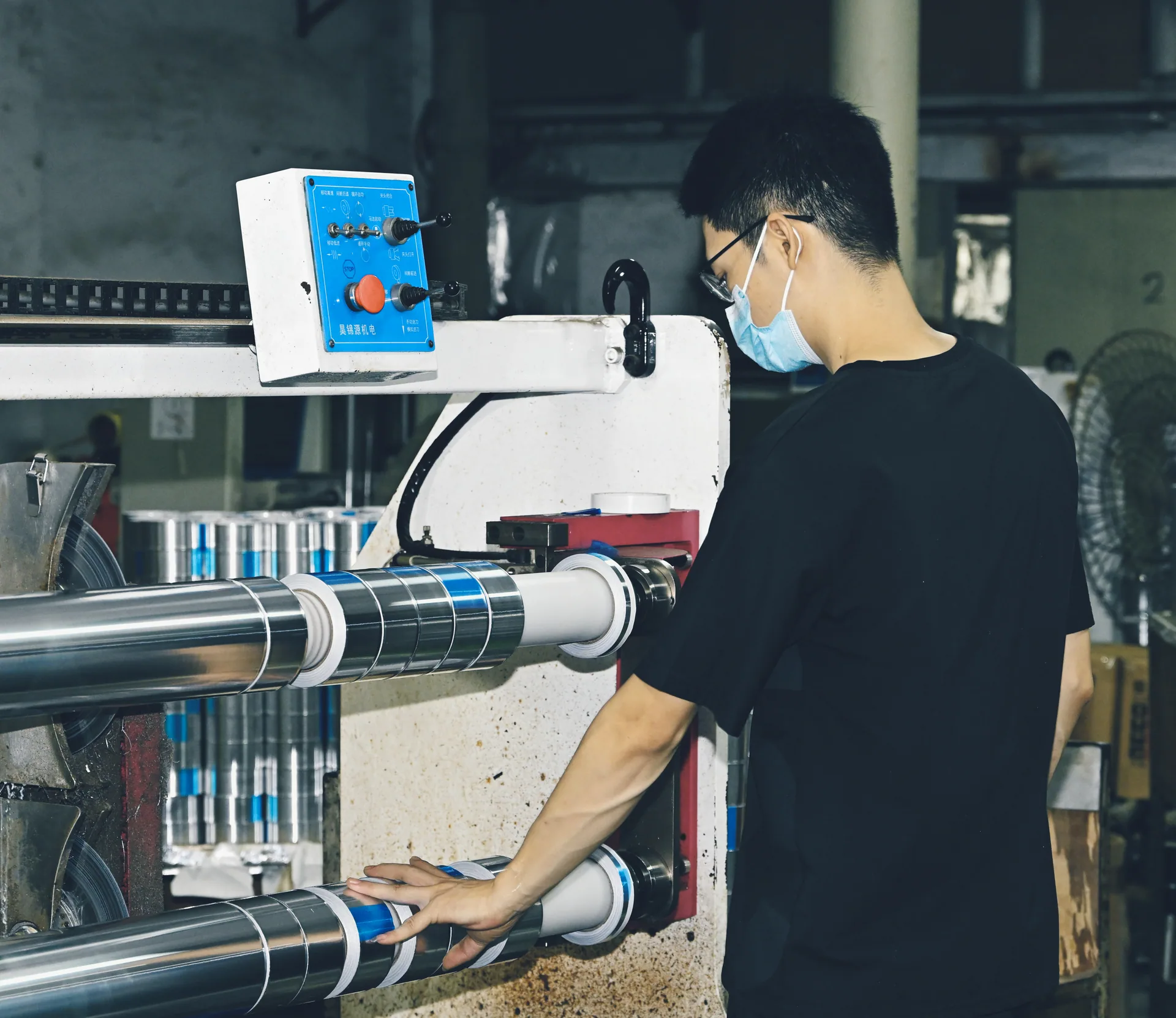 Lead Top employee operating a slitting machine